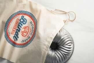 Bundt pan in cloth bag with Nordic Ware logo
