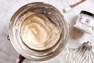 Stand mixer bowl of whipped cream next to Instant Clearjel